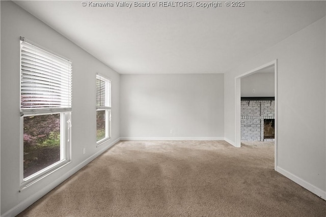 207 Branchfield Dr, Charleston, WV 25314 - carpeted spare room with baseboards and a fireplace