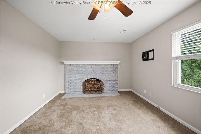 207 Branchfield Dr, Charleston, WV 25314 - unfurnished living room featuring healthy amount of natural light, a ceiling fan, a brick fireplace, and carpet flooring