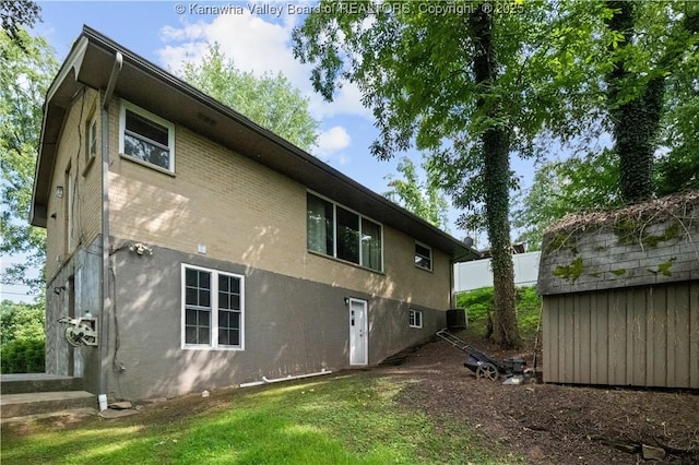 1204 Crown Dr, South Charleston, WV 25309 - back of property featuring stucco siding, a yard, and a shed
