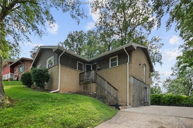 1204 Crown Dr, South Charleston, WV 25309 - back of house with brick siding, a yard, concrete driveway, and stairs