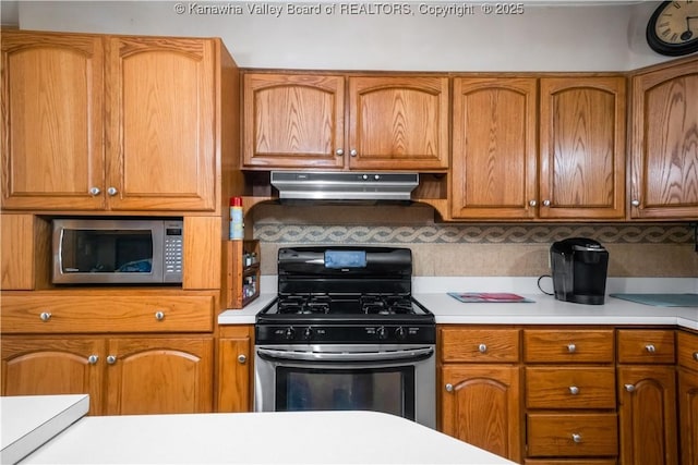 1204 Crown Dr, South Charleston, WV 25309 - kitchen featuring stainless steel appliances, under cabinet range hood, light countertops, and brown cabinets