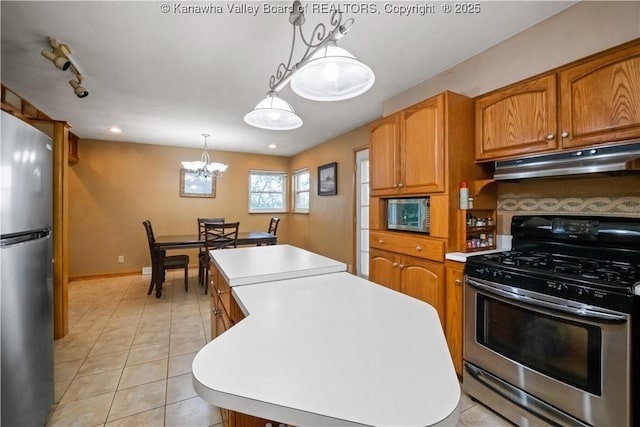 1204 Crown Dr, South Charleston, WV 25309 - kitchen with stainless steel appliances, a center island, under cabinet range hood, and light countertops