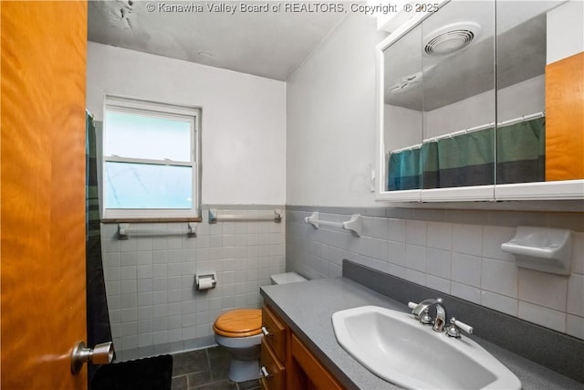 1204 Crown Dr, South Charleston, WV 25309 - full bathroom featuring vanity, tile walls, a shower with shower curtain, and wainscoting