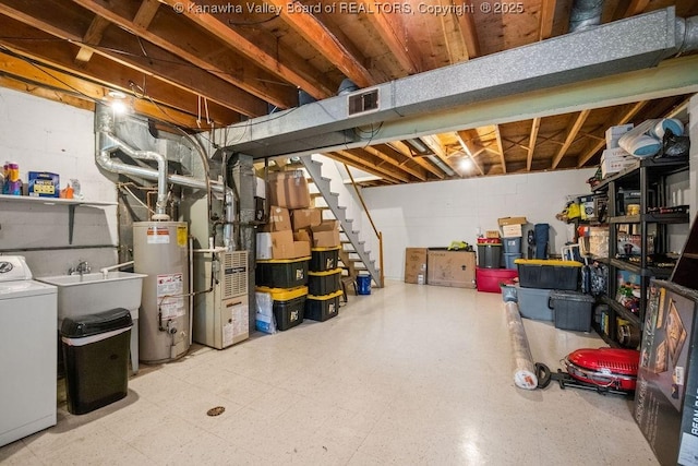 1013 Walnut Rd Unit 4, Charleston, WV 25314 - unfinished below grade area with washer / dryer, gas water heater, heating unit, tile patterned floors, and stairs