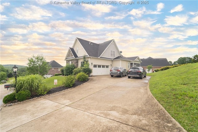 365 Tyler Way, Scott Depot, WV 25560 - view of front of home featuring board and batten siding, concrete driveway, a lawn, and a garage