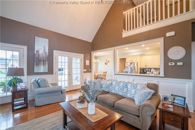 365 Tyler Way, Scott Depot, WV 25560 - living room featuring wood finished floors, a decorative wall, a wainscoted wall, and french doors