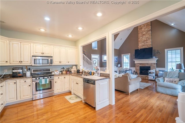 365 Tyler Way, Scott Depot, WV 25560 - kitchen with appliances with stainless steel finishes, open floor plan, light wood-type flooring, recessed lighting, and a fireplace