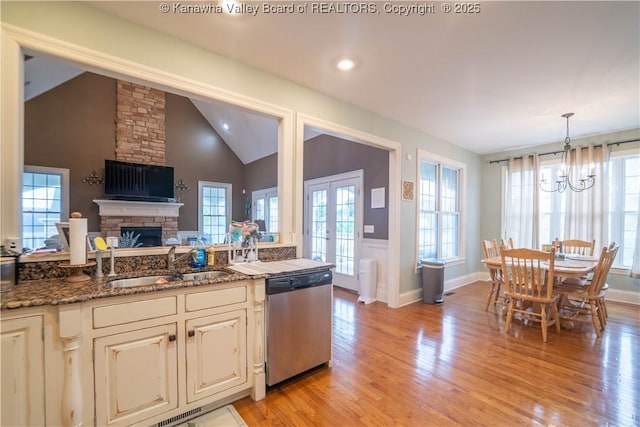 365 Tyler Way, Scott Depot, WV 25560 - kitchen featuring dishwasher, a chandelier, light wood-style flooring, lofted ceiling, and a fireplace