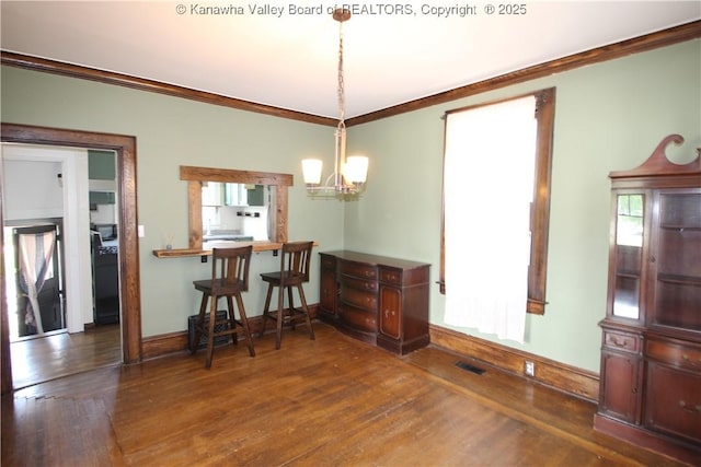 624 Randolph St, Charleston, WV 25302 - dining space with ornamental molding, a chandelier, and wood finished floors