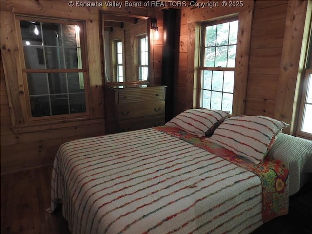 5609 Hurricane Creek Rd, Hurricane, WV 25526 - bedroom with wood walls, multiple windows, and wood finished floors