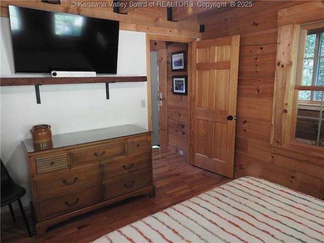 5609 Hurricane Creek Rd, Hurricane, WV 25526 - bedroom with wood finished floors and wooden walls