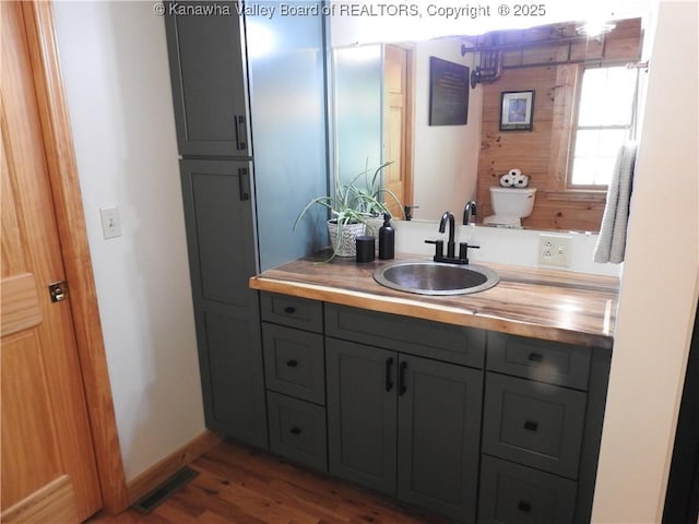 5609 Hurricane Creek Rd, Hurricane, WV 25526 - bathroom featuring vanity and wood finished floors