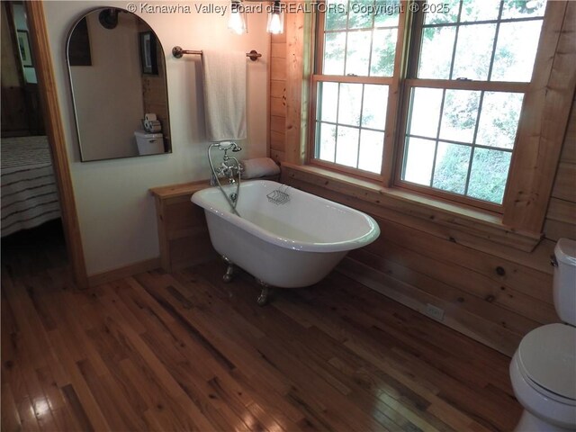 5609 Hurricane Creek Rd, Hurricane, WV 25526 - bathroom with a freestanding tub and wood finished floors