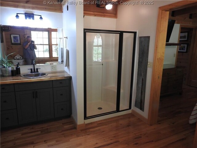 5609 Hurricane Creek Rd, Hurricane, WV 25526 - bathroom with wood finished floors, a shower stall, and vanity