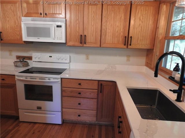 5609 Hurricane Creek Rd, Hurricane, WV 25526 - kitchen featuring white appliances, wood finished floors, light stone countertops, and brown cabinetry