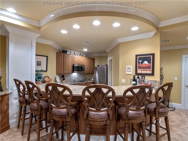 948 Little Coal River Rd, Alum Creek, WV 25003 - kitchen with stainless steel appliances, a peninsula, recessed lighting, crown molding, and backsplash