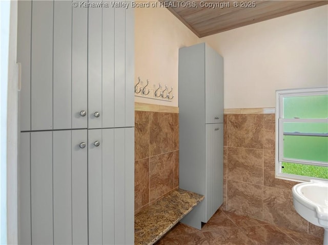 948 Little Coal River Rd, Alum Creek, WV 25003 - bathroom featuring tile walls, a wainscoted wall, and ornamental molding