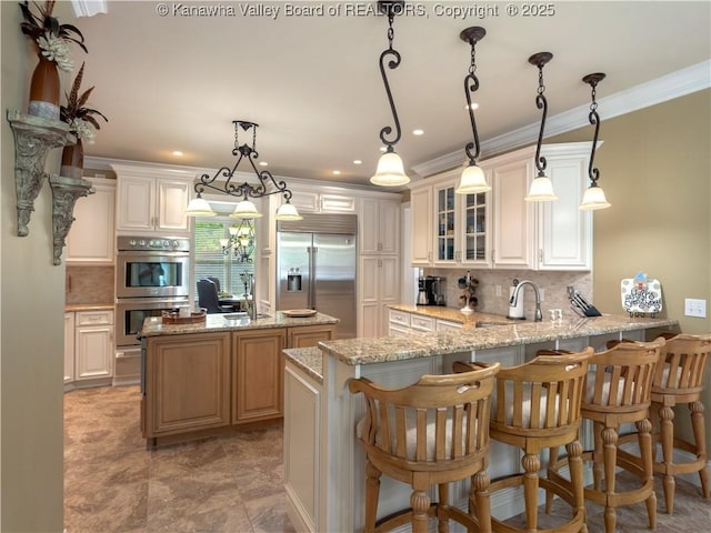 948 Little Coal River Rd, Alum Creek, WV 25003 - kitchen with appliances with stainless steel finishes, decorative backsplash, a peninsula, glass insert cabinets, and crown molding
