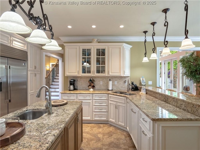 948 Little Coal River Rd, Alum Creek, WV 25003 - kitchen with built in refrigerator, ornamental molding, tasteful backsplash, glass insert cabinets, and a peninsula