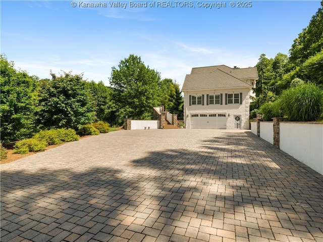 948 Little Coal River Rd, Alum Creek, WV 25003 - view of front facade featuring stairs, an attached garage, and driveway
