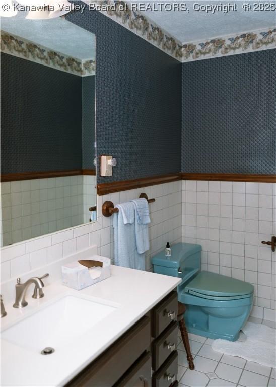 35 Belpac Cir, Logan, WV 25601 - half bath with tile walls, vanity, tile patterned flooring, and wallpapered walls