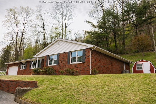 35 Belpac Cir, Logan, WV 25601 - ranch-style home with an attached garage, brick siding, a front lawn, and a storage unit