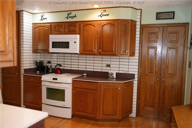 35 Belpac Cir, Logan, WV 25601 - kitchen featuring white appliances, tasteful backsplash, brown cabinetry, and a textured ceiling