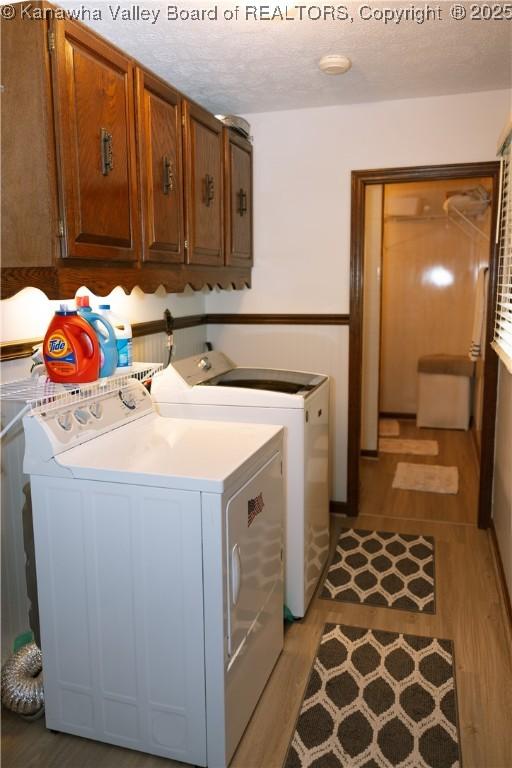 35 Belpac Cir, Logan, WV 25601 - laundry room with cabinet space, independent washer and dryer, and light wood-style flooring