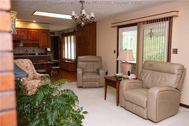 35 Belpac Cir, Logan, WV 25601 - living area featuring a chandelier, a textured ceiling, and light colored carpet