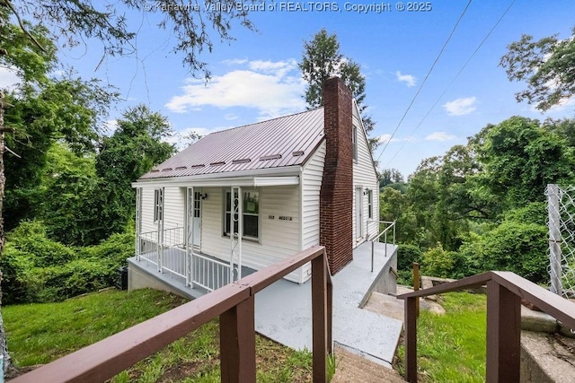 528 Medina St, Charleston, WV 25302 - view of front facade featuring a chimney, covered porch, and a metal roof