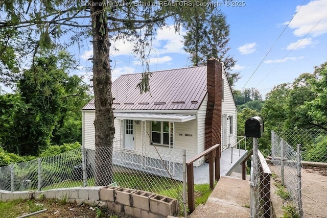 528 Medina St, Charleston, WV 25302 - view of front of property featuring a fenced front yard, a chimney, and a metal roof