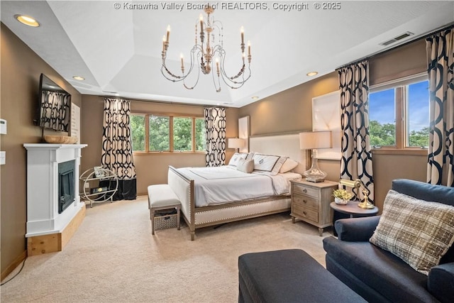 137 Summit Ridge Rd, Hurricane, WV 25526 - carpeted bedroom featuring a chandelier, a raised ceiling, a fireplace with raised hearth, and recessed lighting