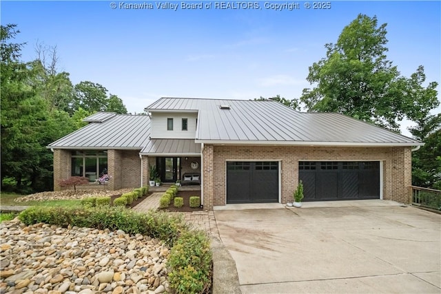 137 Summit Ridge Rd, Hurricane, WV 25526 - view of front of home featuring brick siding, a metal roof, covered porch, concrete driveway, and a standing seam roof