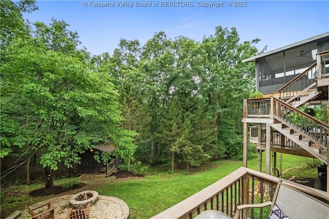 137 Summit Ridge Rd, Hurricane, WV 25526 - view of grassy yard with a fire pit, stairs, a wooden deck, and a sunroom