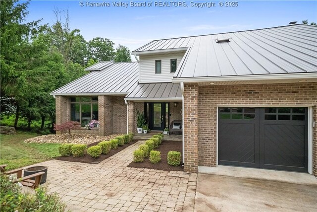137 Summit Ridge Rd, Hurricane, WV 25526 - view of front of property featuring a standing seam roof, driveway, a metal roof, and brick siding
