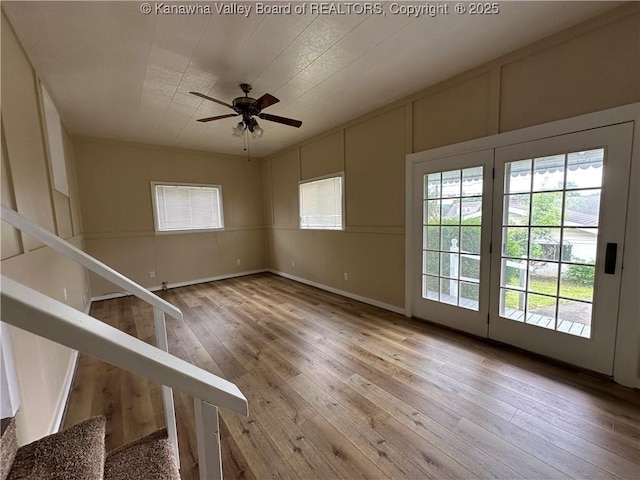 2309 Jefferson Ave, Point Pleasant, WV 25550 - empty room featuring a decorative wall, wood-type flooring, a ceiling fan, and stairway