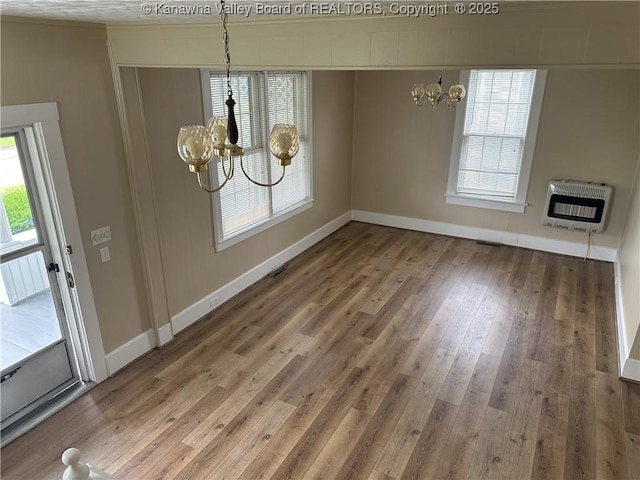 2309 Jefferson Ave, Point Pleasant, WV 25550 - unfurnished dining area with heating unit, a chandelier, plenty of natural light, and wood finished floors