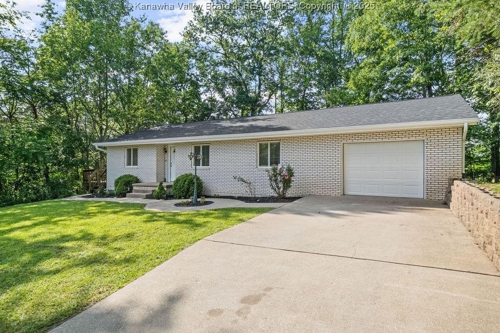 4015 Seymour Ln, Charleston, WV 25313 - single story home featuring driveway, brick siding, a garage, and a front yard