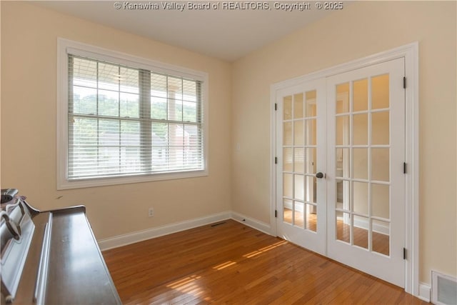 705 Christian Dr, Charleston, WV 25314 - unfurnished dining area featuring french doors and hardwood / wood-style flooring
