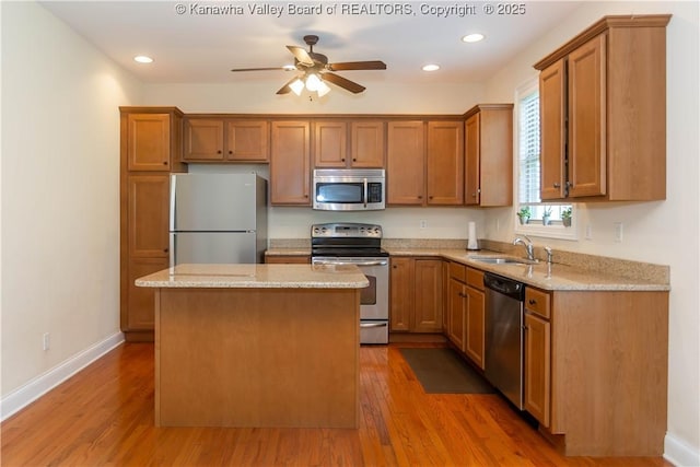 705 Christian Dr, Charleston, WV 25314 - kitchen featuring stainless steel appliances, a center island, wood finished floors, a ceiling fan, and brown cabinets