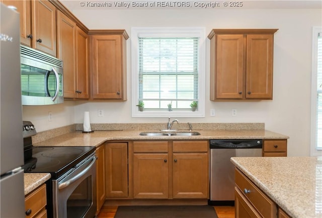 705 Christian Dr, Charleston, WV 25314 - kitchen featuring stainless steel appliances, plenty of natural light, and brown cabinets