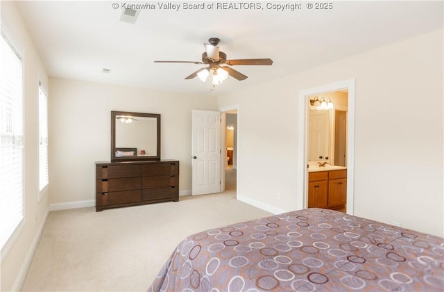 705 Christian Dr, Charleston, WV 25314 - carpeted bedroom with ensuite bath and a ceiling fan