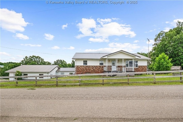 733 Divide Ridge Rd, Given, WV 25245 - view of front of property featuring a porch, a fenced front yard, a metal roof, and brick siding