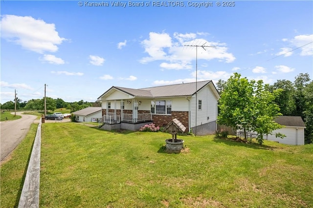 733 Divide Ridge Rd, Given, WV 25245 - rear view of property featuring covered porch, a yard, brick siding, and a metal roof