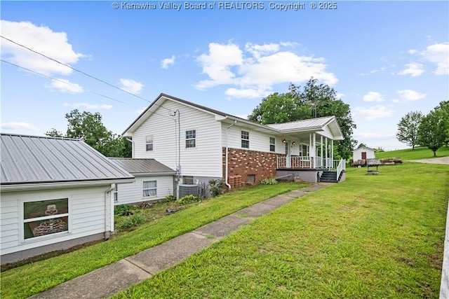 733 Divide Ridge Rd, Given, WV 25245 - view of home's exterior featuring a porch, a lawn, brick siding, and a metal roof