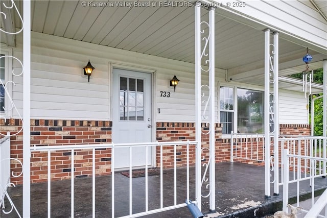 733 Divide Ridge Rd, Given, WV 25245 - view of exterior entry with a porch and brick siding