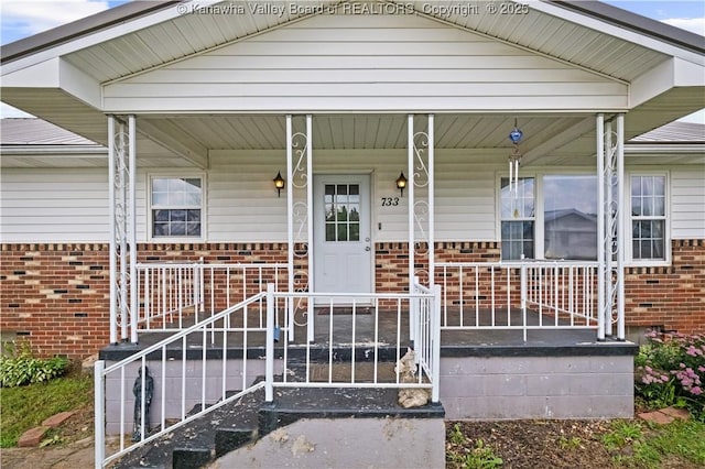733 Divide Ridge Rd, Given, WV 25245 - entrance to property featuring brick siding and a porch