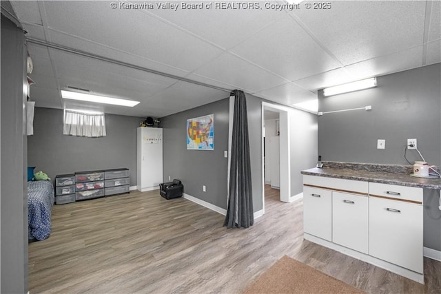 733 Divide Ridge Rd, Given, WV 25245 - kitchen featuring a drop ceiling, light wood-style flooring, white cabinets, and dark countertops