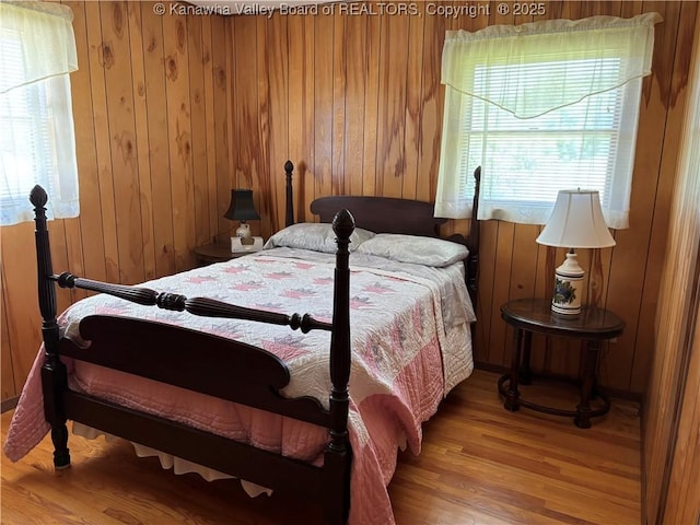 123 2nd St, Burnsville, WV 26335 - bedroom with light wood-style floors and wooden walls