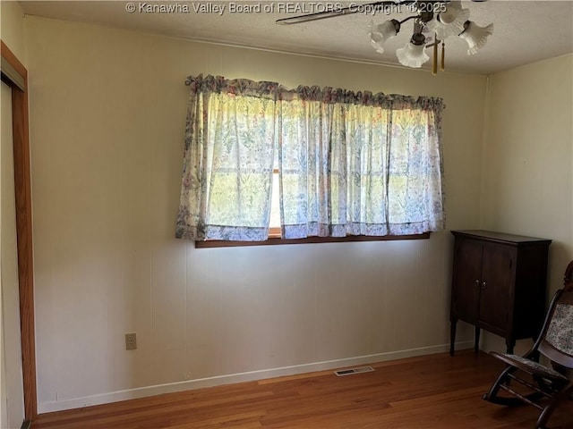 123 2nd St, Burnsville, WV 26335 - sitting room with healthy amount of natural light, a ceiling fan, wood finished floors, and a textured ceiling